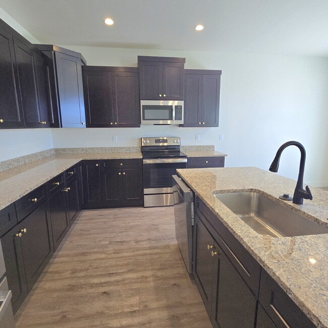 Photo - Move-in ready! 4 bedroom house with 3 car ... Unit (Cottage Gardens)