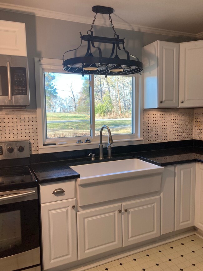 Kitchen with farm sink and granite countertops - 2227 Wildcat Creek Rd Unit A