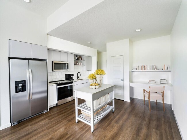 A light-cabinet kitchen with a movable island offers flexible, effortless living throughout your Modera Encore Tampa home.
