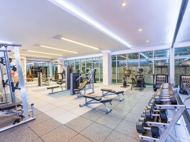 HIIT-inspired fitness studio features a TRX system, smart mirror, and both indoor and outdoor workout spaces, catering to diverse fitness preferences.