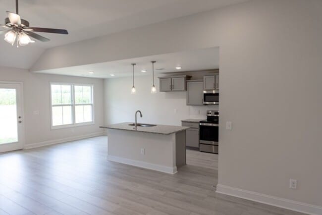 Photo - Modern Living Redefined with Stone Fireplace, Gray Cabinetry, Spa Inspired Primary Suite and Cove...