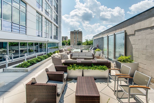 Outdoor patio with grills and seating space at Leo