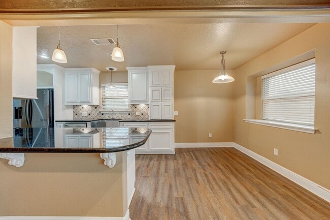 Photo - This charming 3-bedroom, 2-bathroom oasis ...