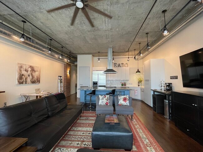 Sala de estar, cocina y comedor de planta abierta. - 505 Bastrop St Unidad 306