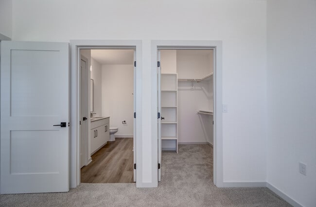 Two side-by-side doors reveal everything you'd expect from a primary suite — a private bathroom and a walk-in closet with custom shelving. - Garrett Forum