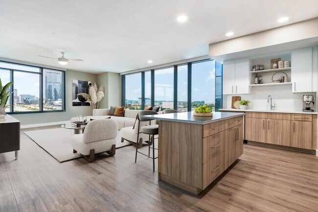 Enjoy a modern kitchen with 42” soft-close cabinetry with under cabinet lighting, quartz counters, and open shelving for added function and style. - Modera McGavock