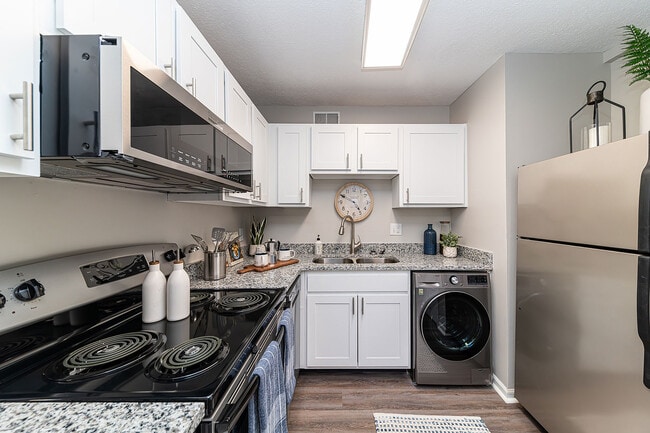 Kitchen with granite counters, stainless appliances, and modern cabinetry