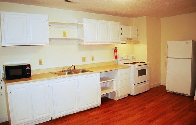 View of the kitchen taken from hall to living room. Fridge is in alcove to the right. - 1728 I St Unit 3