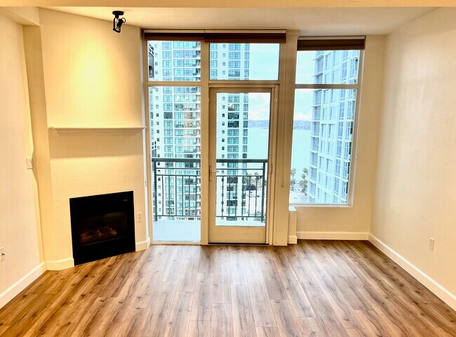 After renovation, living area with gas fire, private balcony and views - 1240 India St Unit 1906
