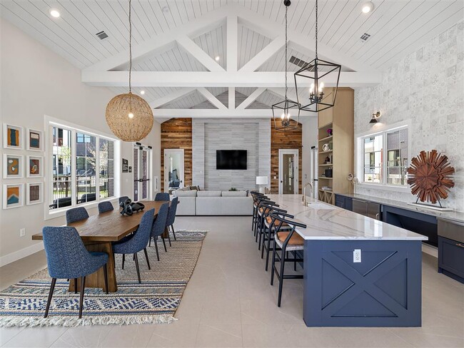 A modern dining room with a wooden table and chairs. - The Avery