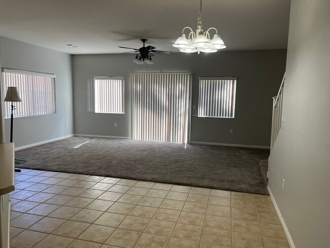 Dining area tiled space under the chandelier. Family room carpeted - 9303 Gilcrease Ave