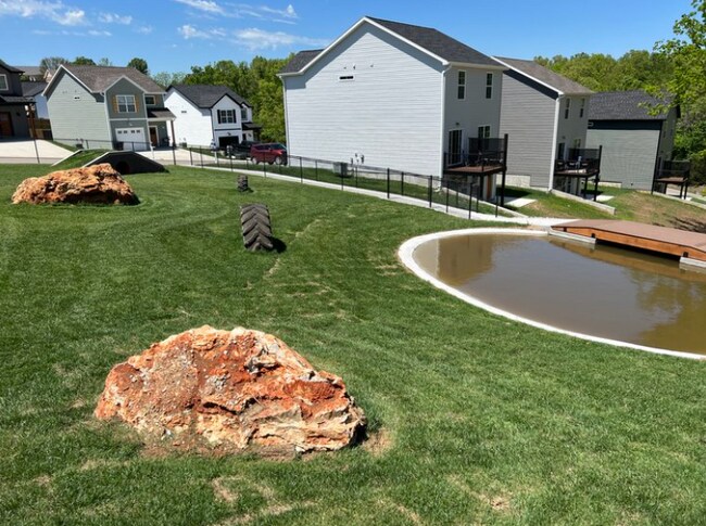 Community dog park with splash pond and dog obstacle course