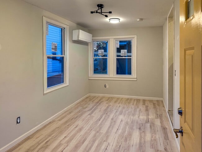 Livingroom with wall mounted heat and air system - 511 Spottswood St Unit B