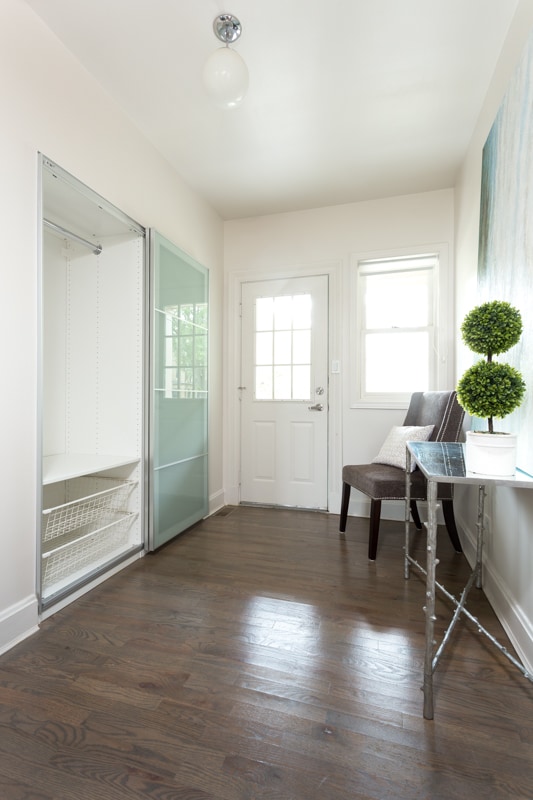 The foyer of this lovely townhome welcomes you to all the essentials: a custom closet and the perfect spot to kick off your shoes and come home to relax. - Westover Townhomes