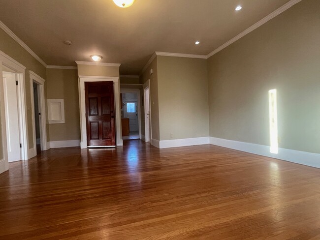 A view of the entrance, with the bathroom door to the right, and the kitchen past that. - 286 19th Ave Apartamentos Unidad C