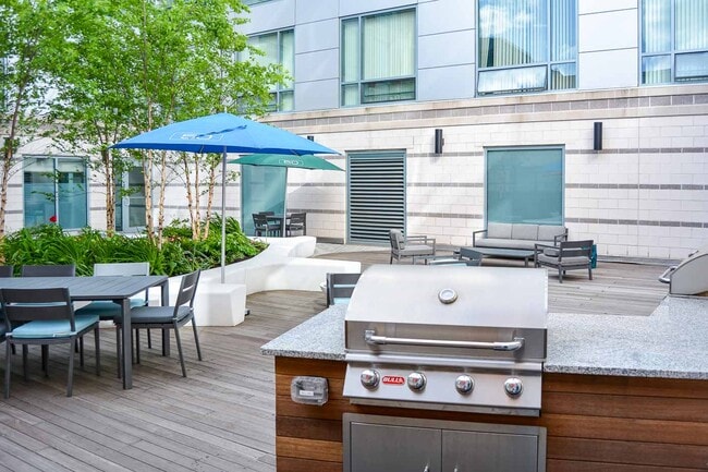 50 West Broadway's Courtyard with Lunch Tables & Grills