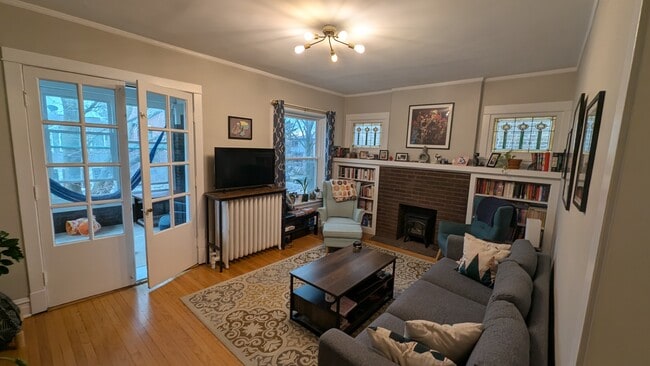Living room with sunporch and large window and stained glass - 2176 W Windsor Ave