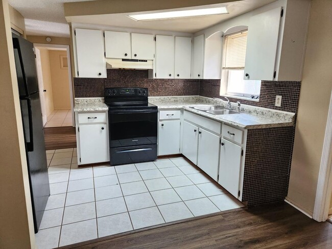 Photo - 3 bedroom, 2 FULL bathroom, 1320sq ft home with LVP flooring, spacious kitchen a LARGE backyard w...