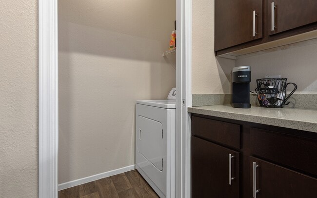 Machines sit in the apartment, right off the kitchen counter run.