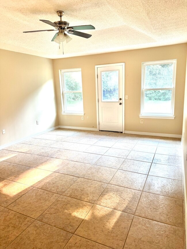 Master bedroom with tile flooring and ample natural light for multiple windows - 6281 Hunters Ridge Dr