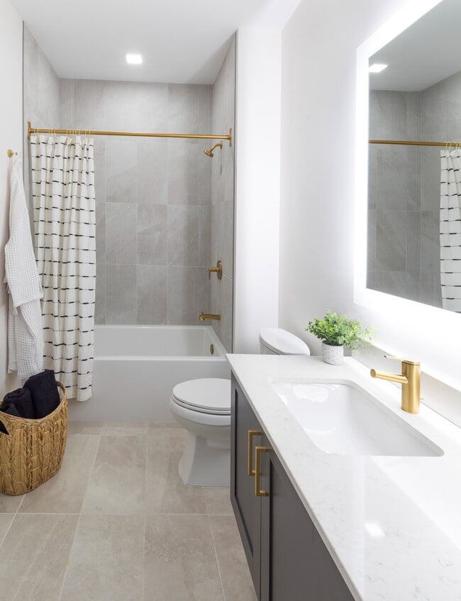 Serene bathroom featuring an LED backlit mirror and premium fixtures