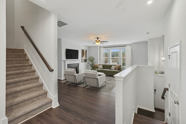Upgrade Package Living room with hard-surface vinyl plank flooring throughout and fireplace