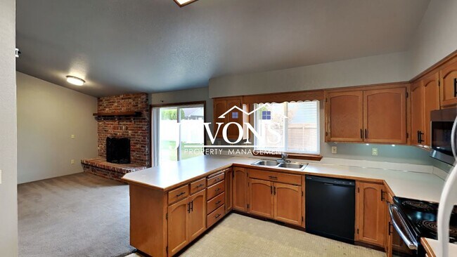 Photo - Enjoy this 3-bedroom home featuring a fully equipped kitchen, a two-car attached garage, and a fe...