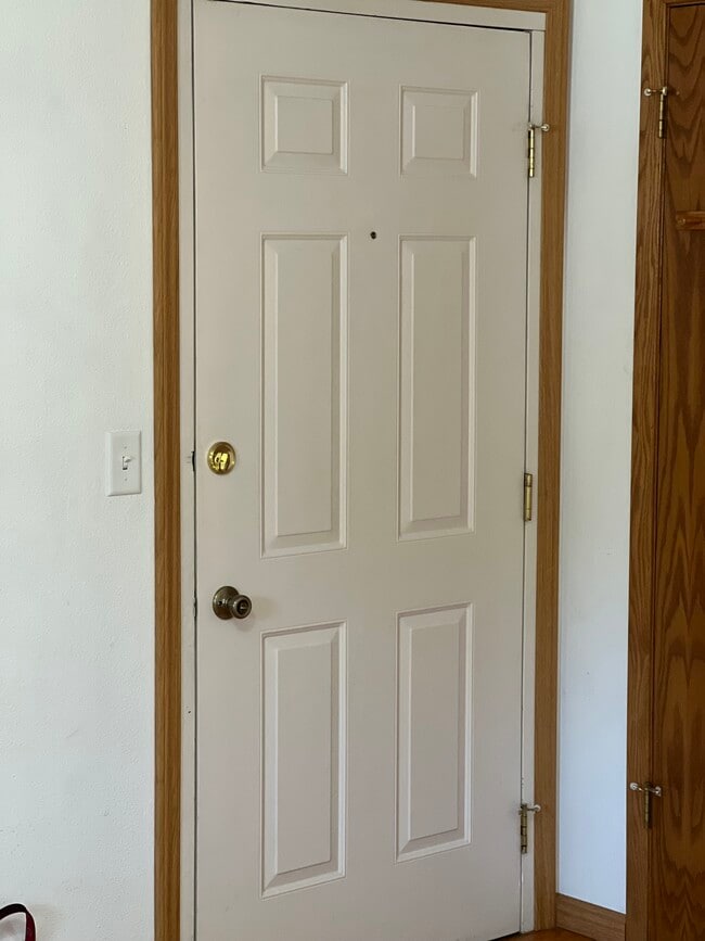 Front door to internal hallway of building - 2902 Shadow Creek Dr Apartment