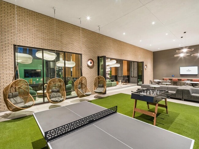Challenge friends to a round of ping-pong or foosball, then kick back in hanging loungers—all under the glow of designer lighting in this stylish indoor-outdoor social space.