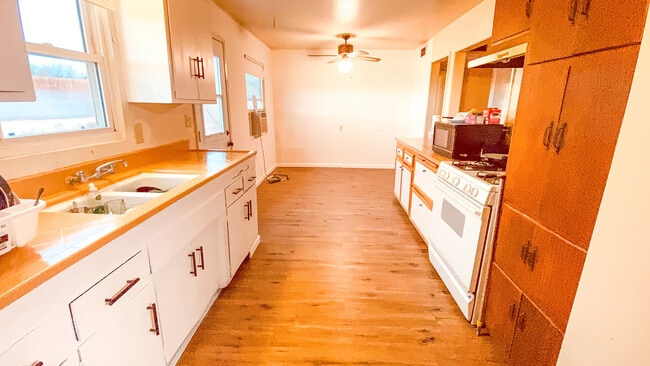Large galley style kitchen with dining room
