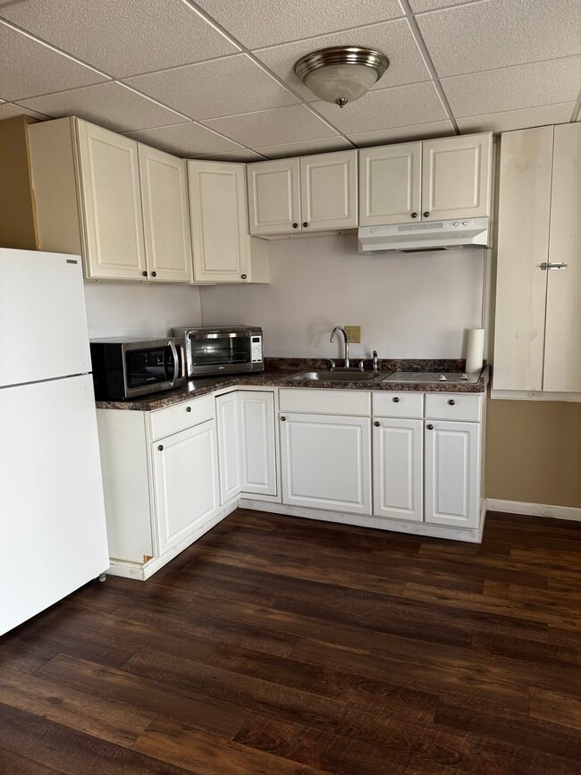 Kitchen with appliances. Microwave, countertop oven, 2 burner built in stove top. - 704 Main St