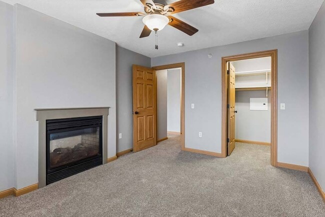 A spacious layout, cozy fireplace, and generous walk-in closet create a bedroom designed for everyday comfort.