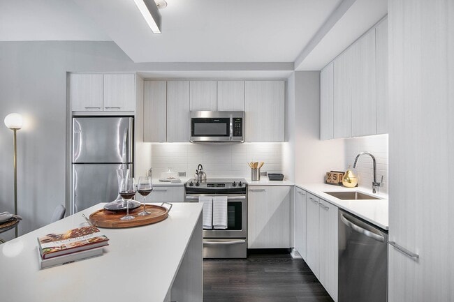 European-style cabinetry with a choice of white wood grain or walnut finishes - Signature Reston Town Center Apartments