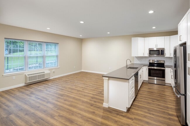 Townhouse Kitchen with Gray Counters and Dining Area