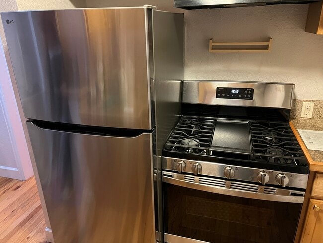Kitchen with new stainless steel stove, dishwasher and refrigerator - 1629 N Clarkson St Unit 36
