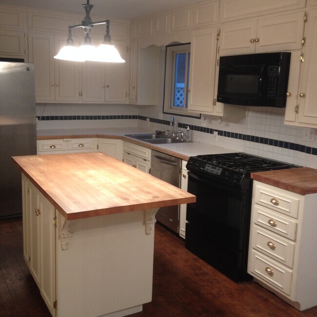 Kitchen with island and newer appliances. - 4515 West 72nd Terrace