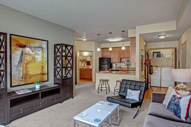 A spacious living room with a view into the kitchen over the bar - Riverside 9