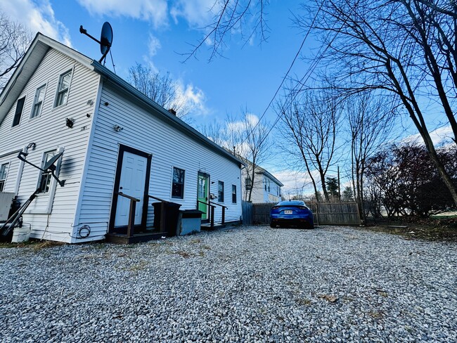 Front door and 4 full sized vehicle parking lot - 128 Main St