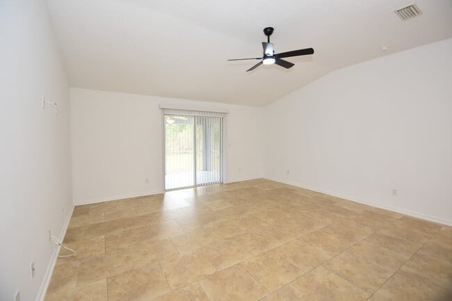 Photo - Fenced yard at this spacious 4-Bedroom Oasis with 2 Baths in Charming Palm Coast Retreat!
