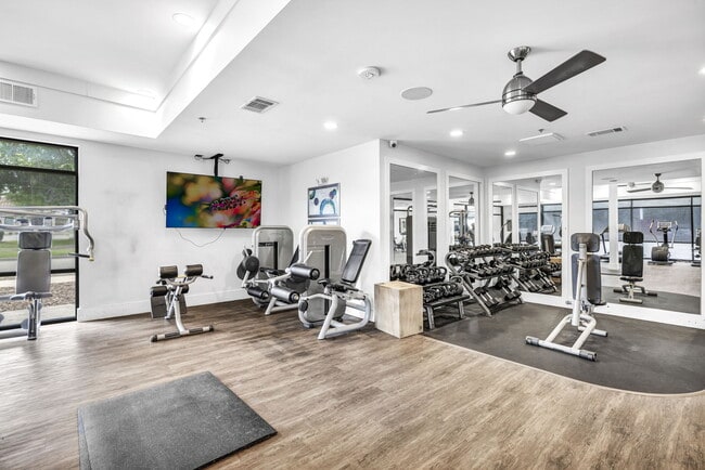 A spacious gym with a mirrored wall at Markethaus 3700 in Plano Texas