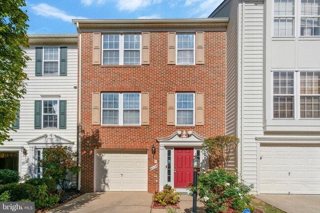 Building Photo - This beautifully maintained brick-front, three-level townhome is located in a highly sought-after...