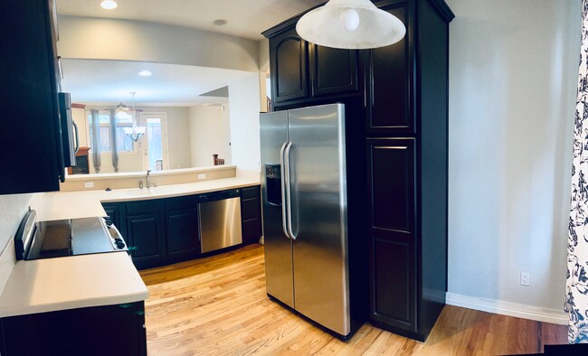 Kitchen with deep cabinets to the right of the fridge and a breakfast nook area. - 2317 Decatur St