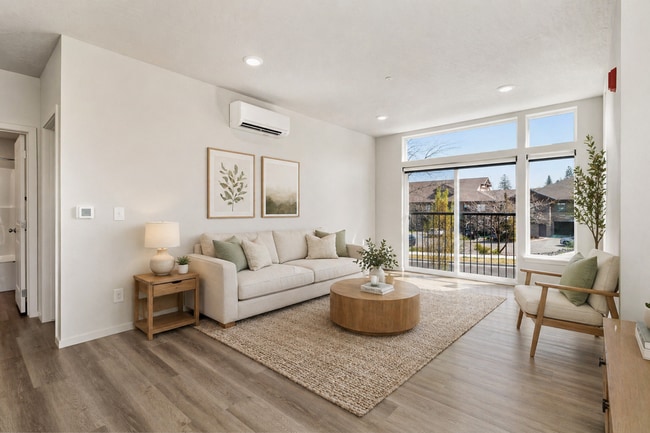 Bright and inviting living room with large windows and natural sunlight.