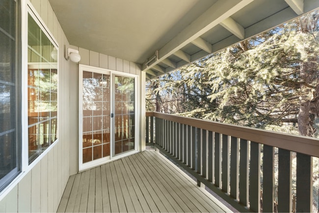 Relax on your private balcony with peaceful wooded views