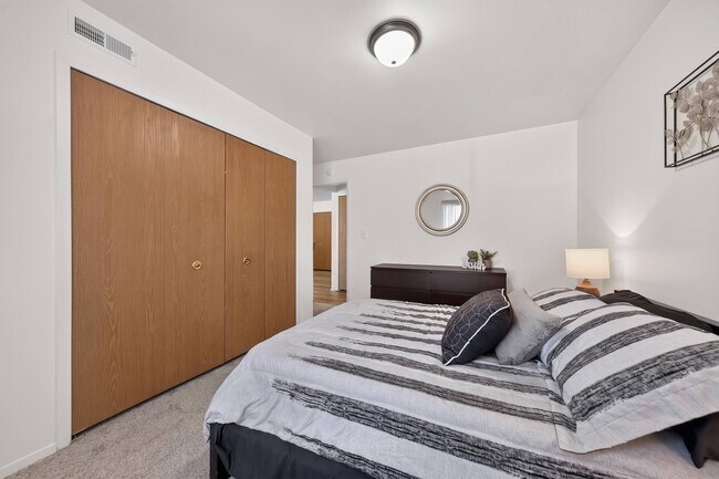 Bedroom with ample storage space at Eastwood Village Apartments in Clinton Township, MI.