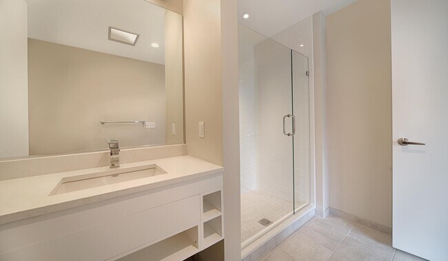 Bathrooms feature modern cabinets, a walk-in shower and a quartz vanity