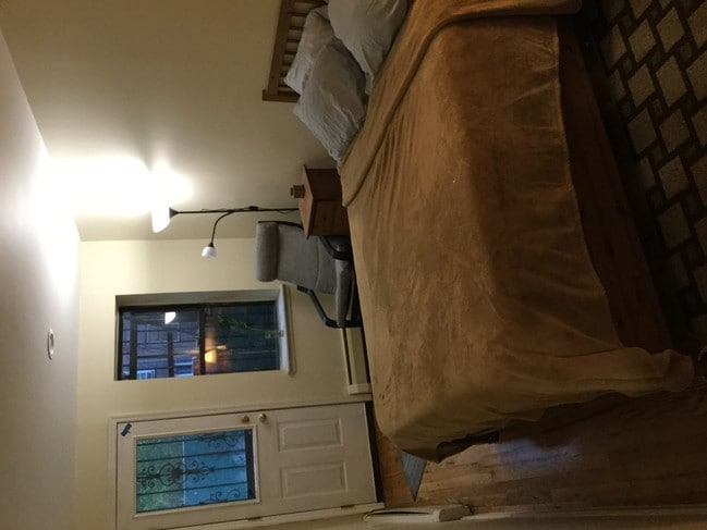 Brown bedroom w/ backyard access - 507 W 173rd St Unit Great garden floor