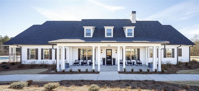 Clubhouse exterior with ample parking for future residents and visitors.
