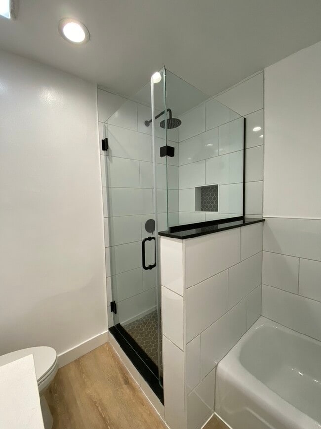 Separate porcelain bathtub and glass shower with luxurious rainfall showerhead - 1203 N Sweetzer Ave Unit 106