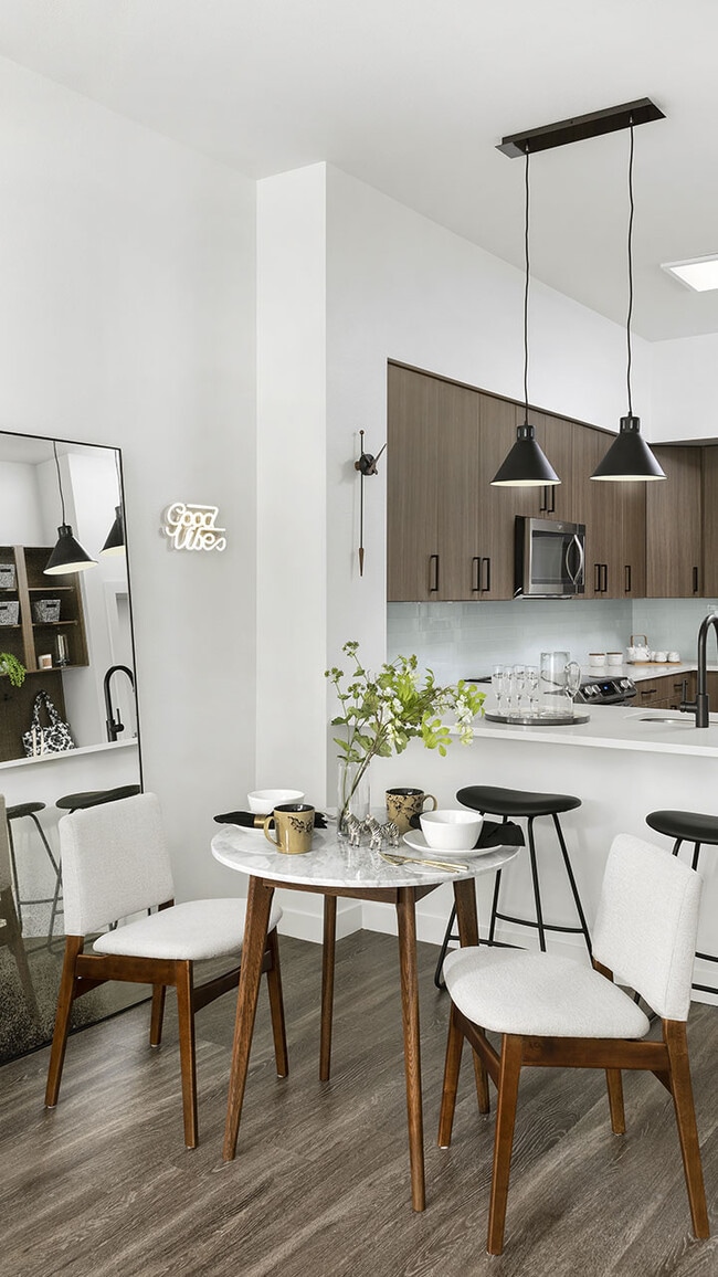 Apartment Kitchen with Stainless Steel Appliances, quartz countertop and hardwood flooring.